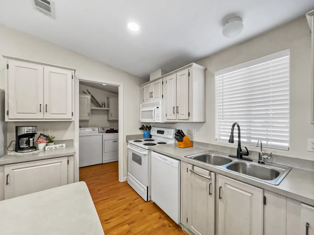 A spacious and well-equipped kitchen, complete with countertops, a sink, and modern appliances, is the focal point. The setup is perfect for cooking, baking, and enjoying family meals together, highlighting the home's appeal for group gatherings and shared experiences.